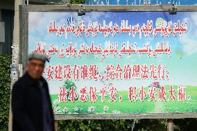 Hotan resident passes by anti-crime signboard