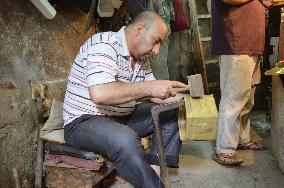 Cairo craftsman works on copper product