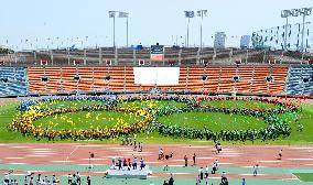 People form Olympic emblem at National Stadium