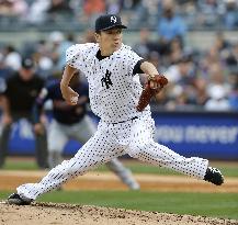 Tanaka earns 8th win