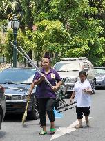Cleaners walk in premises of Thai premier's office