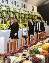 Women weep at memorial service for ferry tragedy victims