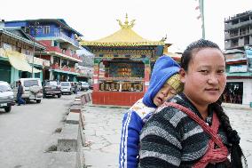 Mother, child in market in Tawang