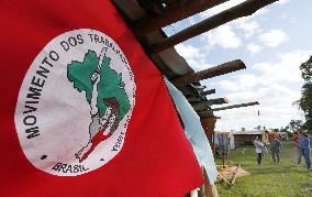 Flag of Brazil's landless farmers' movement hangs at hut