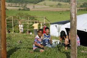 Brazilian kids play on idle land occupied by poor peasants