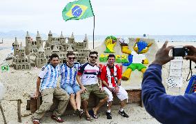 Soccer fans pose before World Cup mascot monument