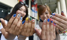 Japanese women show nails designed for World Cup