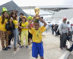 Boy holds 'World Cup' at Arena Corinthians