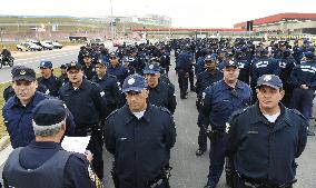 Police officers gather in front of Arena de Sao Paulo