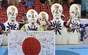 Supporters in unique costumes cheer for Japan