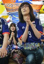 Woman prays for Japan's victory in World Cup