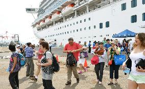 Passengers disembark from cruise ship in Sakaiminato