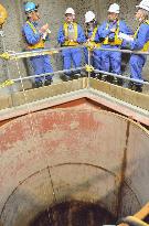 Test burial pit for radioactive waste opened to press