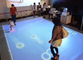 Virtual air hockey projector developed in Osaka