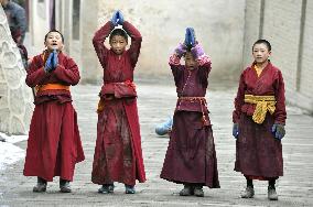 Young lamas walk in prayer in China
