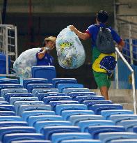 Japanese supporters collect trash after World Cup game