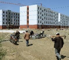 Uyghur workers walk to construction site