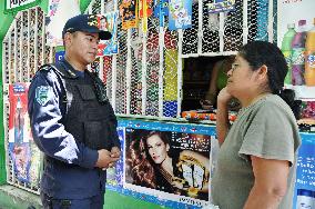 Policeman speaks to shopper