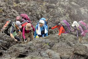People climb Mt. Fuji
