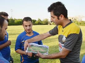 Kurd teaches baseball rules to friends
