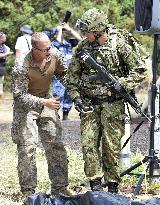 U.S. marine checks JGSDF member's equipment