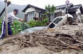 Man clears typhoon-caused dirt, driftwood in Nagano