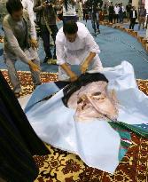 Abdullah supporter tears President Karzai's photo