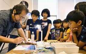Animation art director teaches in class for kids