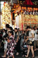 People walk on Kyoto street during Gion Festival