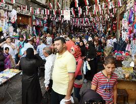 Shoppers at market in Damascus