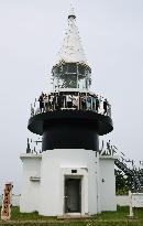 Children cheer from Japan's tallest lighthouse