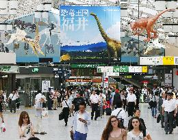 Paper dianosaurs 'gaze down' at people at Ueno Station
