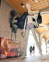 Mockup Godzilla hand grabs giant popular character