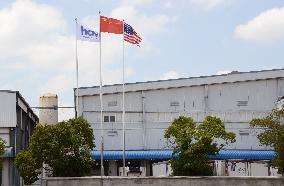 Scandal-hit food maker hoists U.S., China flags at plant