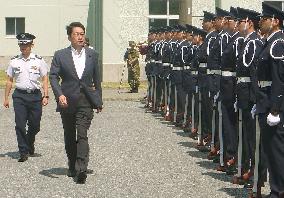 Defense chief Onodera inspects honor guard at northern camp