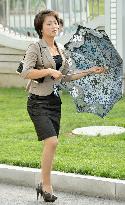 Pyongyang woman walks in heels with colorful parasol