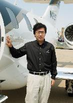 Honda Aircraft President Fujino stands by aircraft