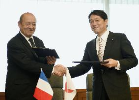 Japan, France defense chiefs shake hands in Tokyo