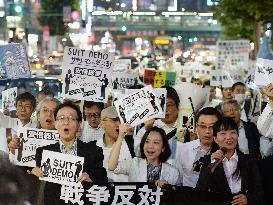 Workers in business wear protest against Abe gov't