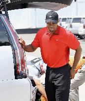 Grimacing Woods gets in car at Firestone CC