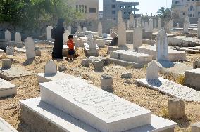 People mourn for loved ones in Gaza cemetery