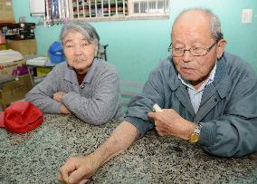 A-bomb victim shows dark mark left on arm after treatment