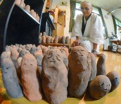 Fukushima nun bakes over 2,600 mud Buddhas for missing