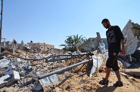 Man walks around destroyed homes in Gaza