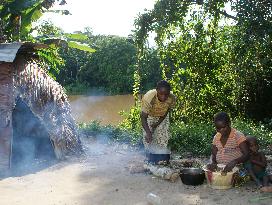 Women cook outdoors in Congo village