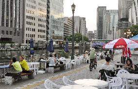 People relax at terrace created along Osaka river