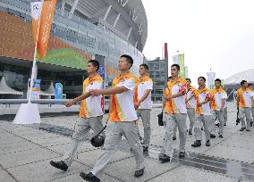 Security officials march around Youth Olympics stadium