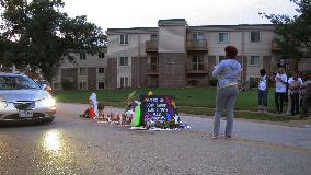 People gather at shooting site in Ferguson, Mo.