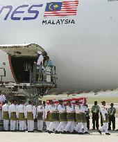 Remains of Malaysian victims arrive home