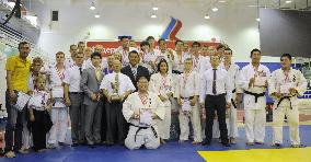 Japanese, Russian HS judo players pose after competition